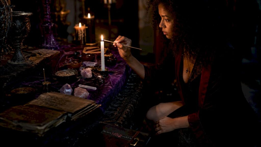 Woman lighting candle for ritual spell
