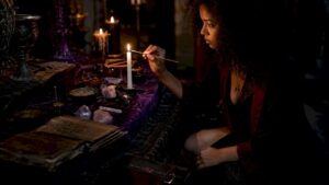 Woman lighting candle for ritual spell