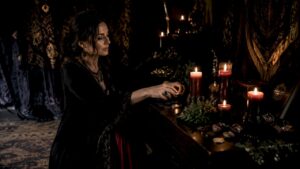 Practitioner arranging money spell ritual altar