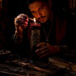 Practitioner lighting seven day candle on altar