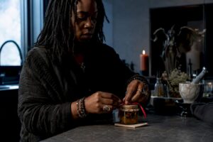 Practitioner sealing a honey jar ritual