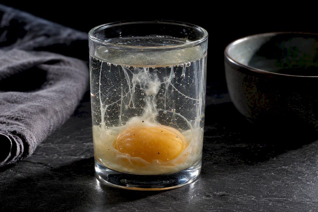 Raw egg white showing bubbles and strands